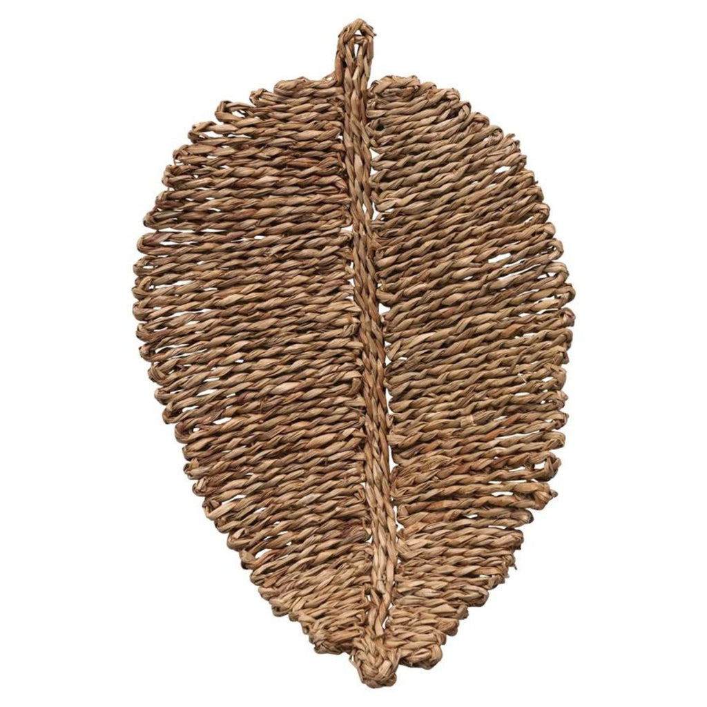 woven seagrass placemat in the shape of a leaf