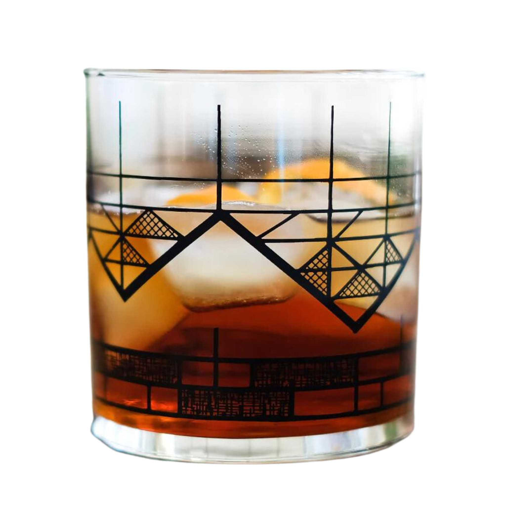 Geometric mountain glass half filled with a drink