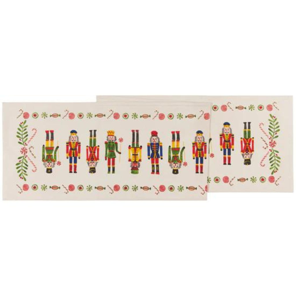 cream colored cotton table runner with row of colorful nutcrackers in center
